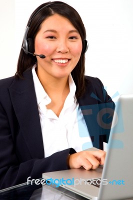 Businesswoman With Headset And Pc Stock Photo