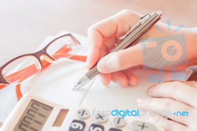 Businesswoman Working With Calculator And Pen Stock Photo