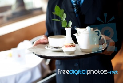 Butler Holding Tea Tray For Guest Stock Photo