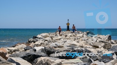 Cabo Pino, Andalucia/spain - July 2 : People Exploring The Rocks… Stock Photo