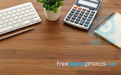 Calculator And Computer Keyboard On Wooden Table Stock Photo