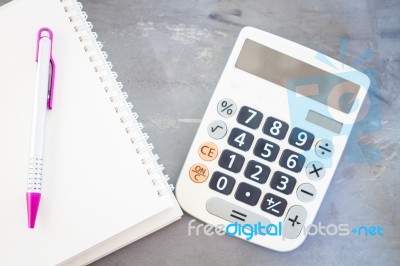 Calculator, Notepad And Pen On Grey Background Stock Photo