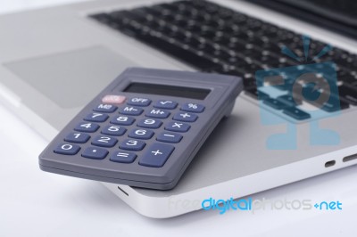 Calculator On The Laptop Keyboard Stock Photo