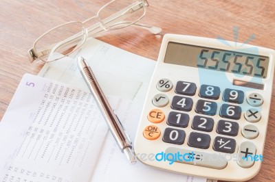 Calculator, Pen And Eyeglasses With Bank Account Passbook Stock Photo