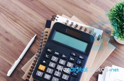 Calculator With Notebook Background Stock Photo