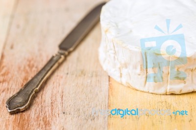 Camembert Cheese And Vintage Knife On Wooden Table Stock Photo