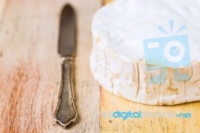 Camembert Cheese And Vintage Knife On Wooden Table Stock Photo