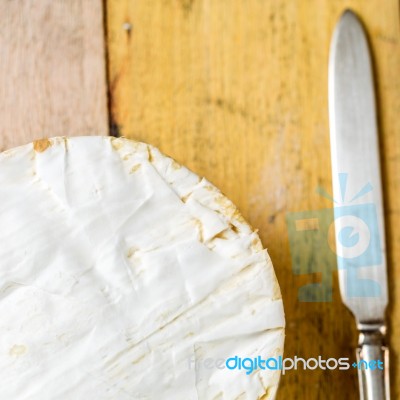 Camembert Cheese And Vintage Knife On Wooden Table Stock Photo