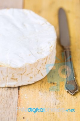 Camembert Cheese And Vintage Knife On Wooden Table Stock Photo