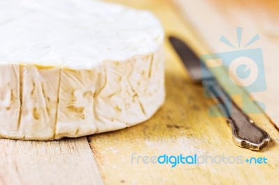 Camembert Cheese And Vintage Knife On Wooden Table Stock Photo