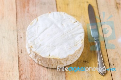 Camembert Cheese And Vintage Knife On Wooden Table Stock Photo