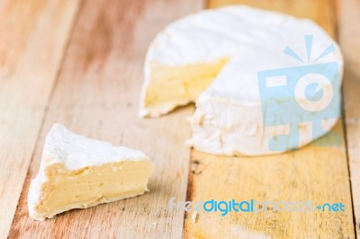 Camembert Cheese With Cut Wedge And Vintage Knife On Wooden Tabl… Stock Photo