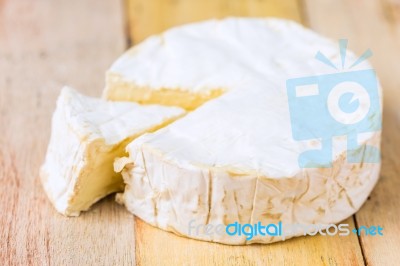 Camembert Cheese With Cut Wedge And Vintage Knife On Wooden Tabl… Stock Photo