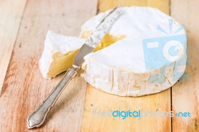 Camembert Cheese With Cut Wedge And Vintage Knife On Wooden Tabl… Stock Photo