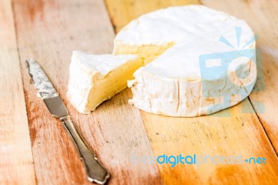 Camembert Cheese With Cut Wedge And Vintage Knife On Wooden Tabl… Stock Photo