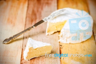 Camembert Cheese With Cut Wedge And Vintage Knife On Wooden Tabl… Stock Photo