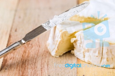 Camembert Cheese With Cut Wedge And Vintage Knife On Wooden Tabl… Stock Photo