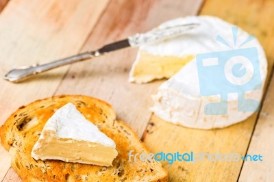 Camembert Cheese With Cut Wedge On Toasted Bread Slice And Vinta… Stock Photo