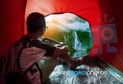 Camping Man In Camper Tent Looking To Beautiful Natural Water Falls Scenic Use For People Vacation Traveling To Destination Stock Photo