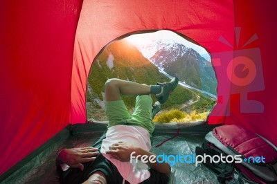 Camping Man Lying In Outdoor Camping Tent With Beautiful Natural Scenic Stock Photo