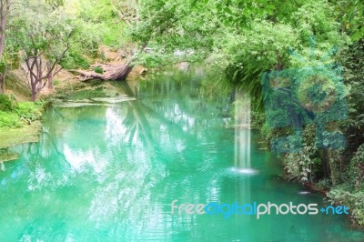 Canal In Tropical Forest And Small Waterfall Stock Photo