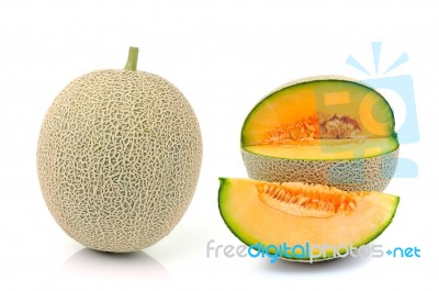 Cantaloupe In Net Bag, Isolated On White Background Stock Photo