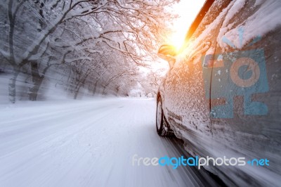 Car And Falling Snow In Winter On Forest Road With Much Snow.(motion Blur) Stock Photo