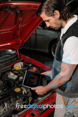 Car Mechanic Using Digital Tablet Stock Photo