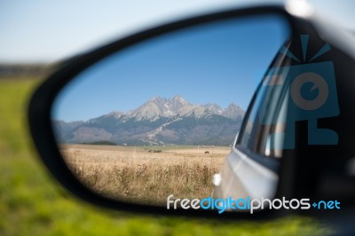 Car Rear View Of High Mountains Stock Photo