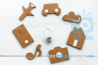 Cardboard Web Icons  And Light Bulb On Blue Background Stock Photo