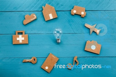 Cardboard Web Icons  And Light Bulb On Blue Background Stock Photo