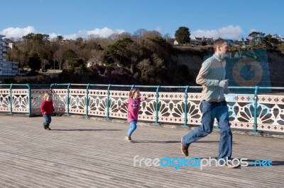 Cardiff Uk March 2014 - Family Playing On Penarth Pier Stock Photo