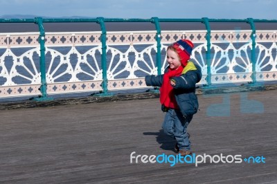 Cardiff Uk March 2014 - Young Boy Chasing His Dad On Penarth Pie… Stock Photo