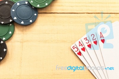 Cards And Poker Chips On Wooden Background Stock Photo