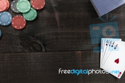 Cards And Poker Chips On Wooden Background Stock Photo