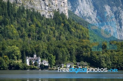 Castle Schloss On The Shoreline Of Lake Hallstatt Stock Photo