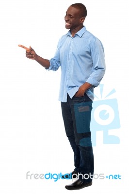 Casual African Man Pointing Away Stock Photo