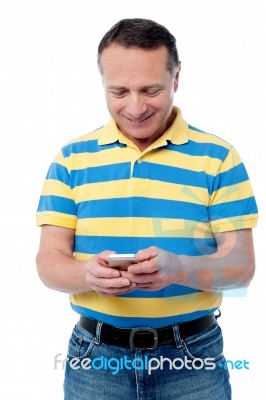 Casual Aged Man Using Mobile Phone Stock Photo