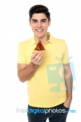 Casual Boy Posing With Pizza Slice Stock Photo