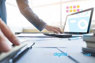 Casual Businessman Working In Office, Sitting At Desk, Typing On… Stock Photo