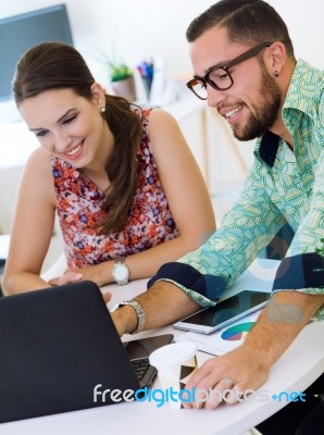 Casual Executives Working Together At A Meeting With Laptop Stock Photo