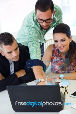 Casual Executives Working Together At A Meeting With Laptop Stock Photo