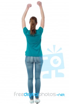 Casual Female Raising Her Hands Stock Photo