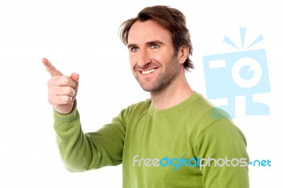 Casual Man Pointing At Something Stock Photo