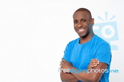 Casual Man Standing With Crossed Arms Stock Photo