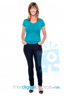 Casual Trendy Woman With Hands In Jeans Pocket Stock Photo