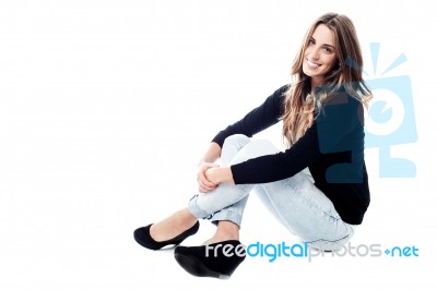 Casual Woman Sitting On The Floor Stock Photo