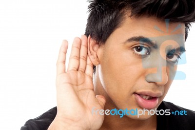 Casual Young Guy Eavesdropping Stock Photo