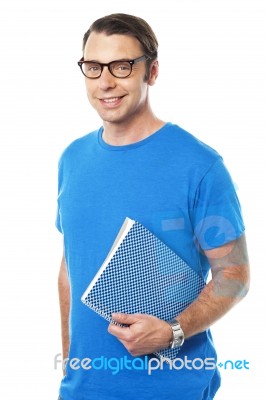 Casual Young Guy Holding Notepad Stock Photo