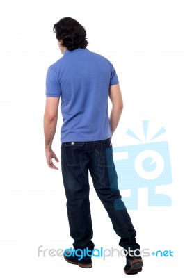 Casual Young Guy Walking In Studio Stock Photo